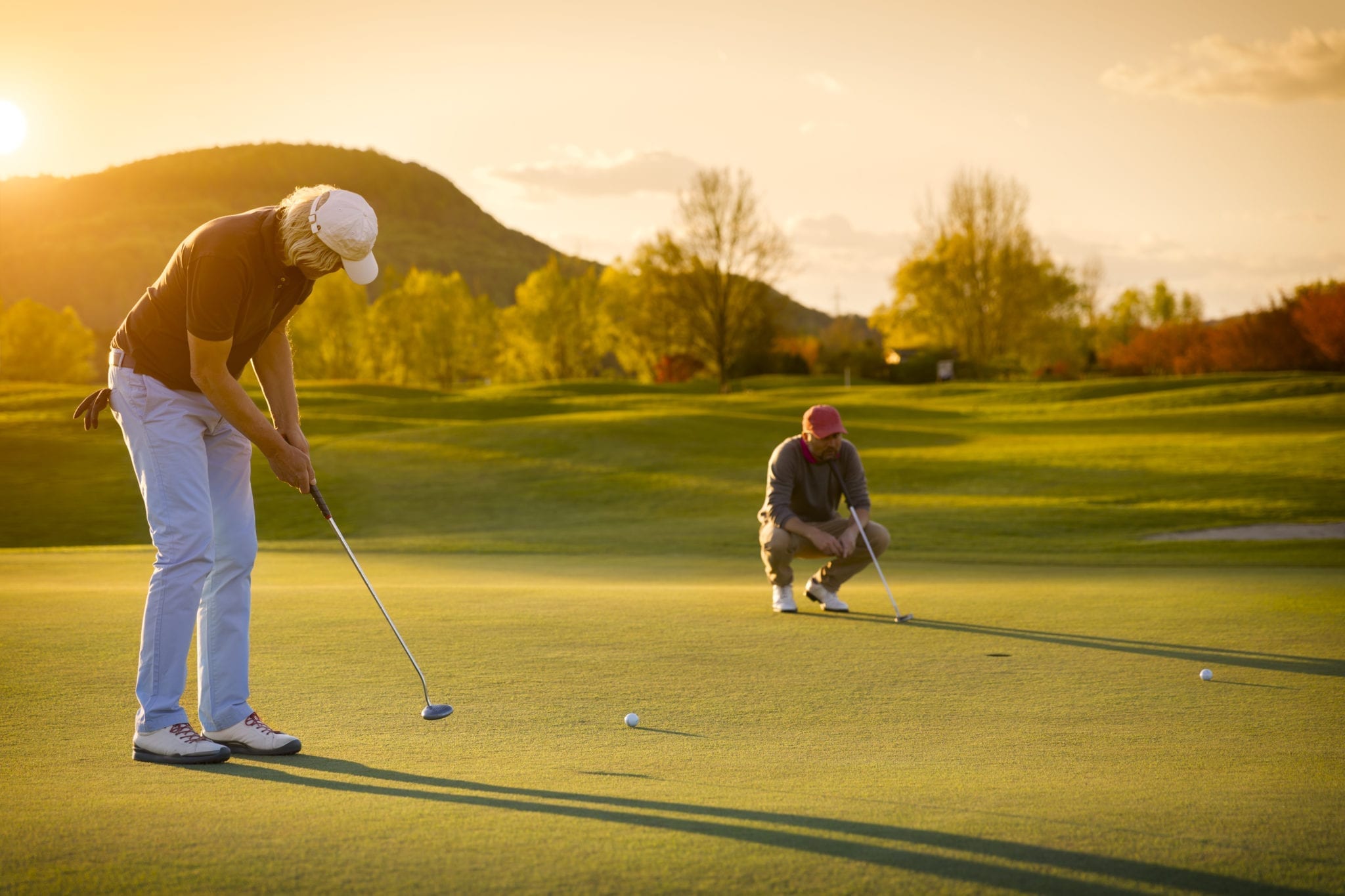 Two senior golf player at sunset. The Whiteface Lodge