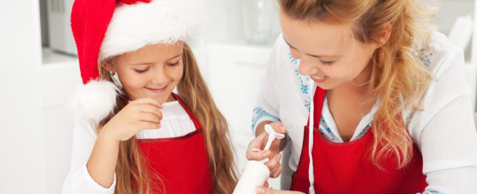 Mother and daughter decorating cookies.