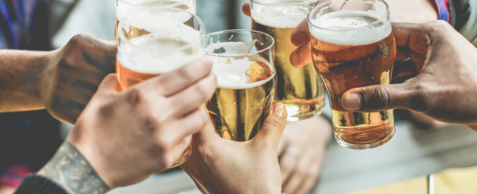 Group toasting with glasses of beer.