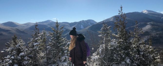 Woman on snowy winter hill.