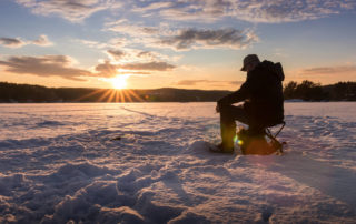 A man ice fishing near Lake Placid, New York