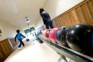 A family bowling at Whiteface Lodge, one of Lake Placid's best rainy day activities