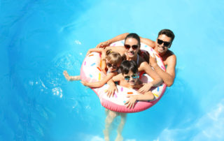 A family on a floaty at a pool in Lake Placid