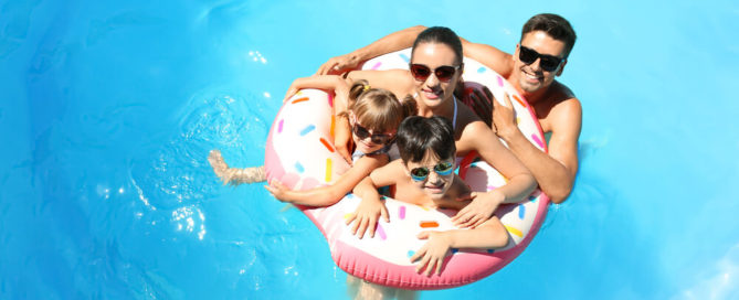 A family on a floaty at a pool in Lake Placid