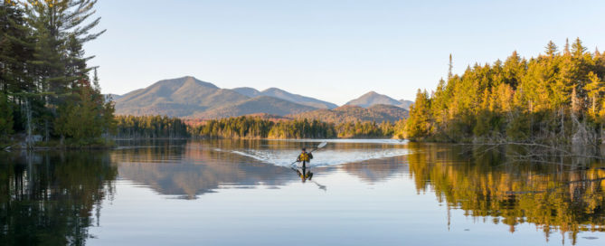 A man kayaking in Lake Placid