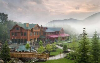 The grounds of Whiteface Lodge with a foggy mountain peak in the background