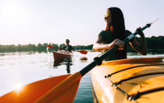 A couple kayaking on Mirror Lake, one of Lake Placid's premier summer activities